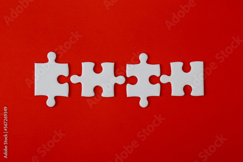 White puzzle pieces on a red background