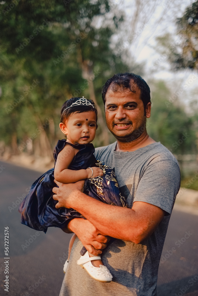 father and child,south asian father holding his daughter in his arms father and child,south asian father holding his daughter in his arms