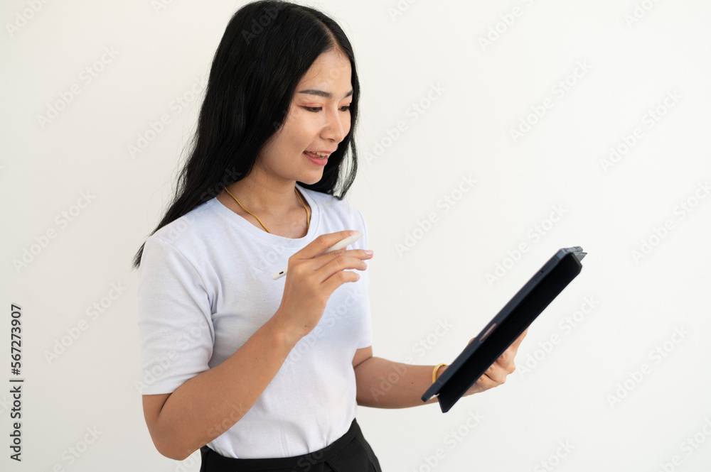 Image of young asian woman, company worker in glasses, smiling and holding digital tablet, standing over white background Image of young asian woman, company worker in glasses, smiling and holding digital tablet, standing over white background