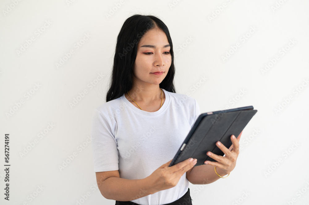 Image of young asian woman, company worker in glasses, smiling and holding digital tablet, standing over white background Image of young asian woman, company worker in glasses, smiling and holding digital tablet, standing over white background