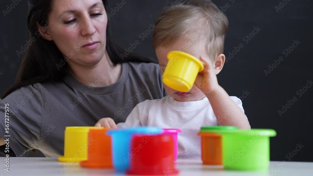 Happy cute family at home. Baby play with colored toys. Educational games for preschooler child. Mom helps child to play and have fun. Family happy education concept. Mom help in learning about world. Happy cute family at home. Baby play with colored toys. Educational games for preschooler child. Mom helps child to play and have fun. Family happy education concept. Mom help in learning about world.