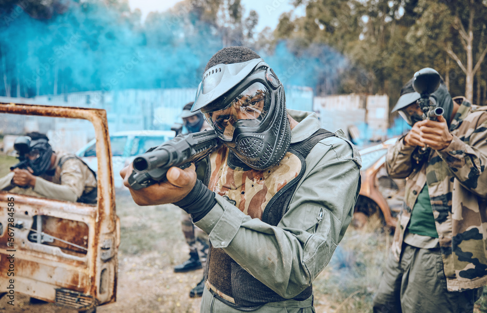 Fototapeta premium Paintball, teamwork and shooting with people in field for sports, target and fitness games. War, smoke and community with man gamer playing in camouflage for military, army and competition training
