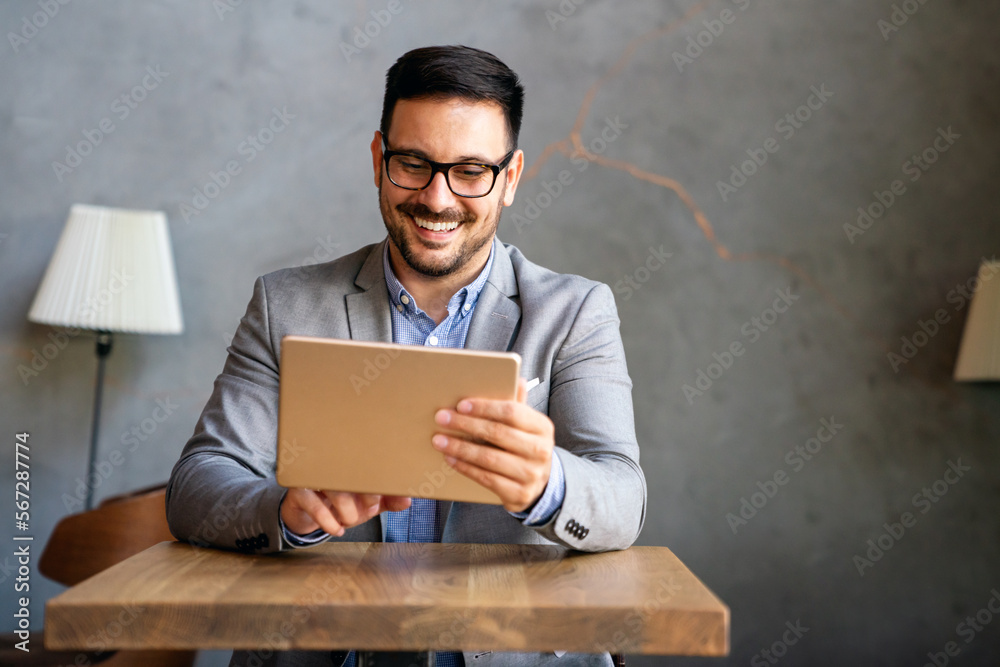 Portrait of young business man working on digital tablet Portrait of young business man working on digital tablet