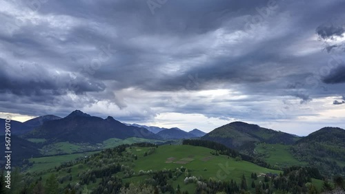 Spring landscape with cumulus clouds Storm clouds form over the mountains at dusk, zoom in photo