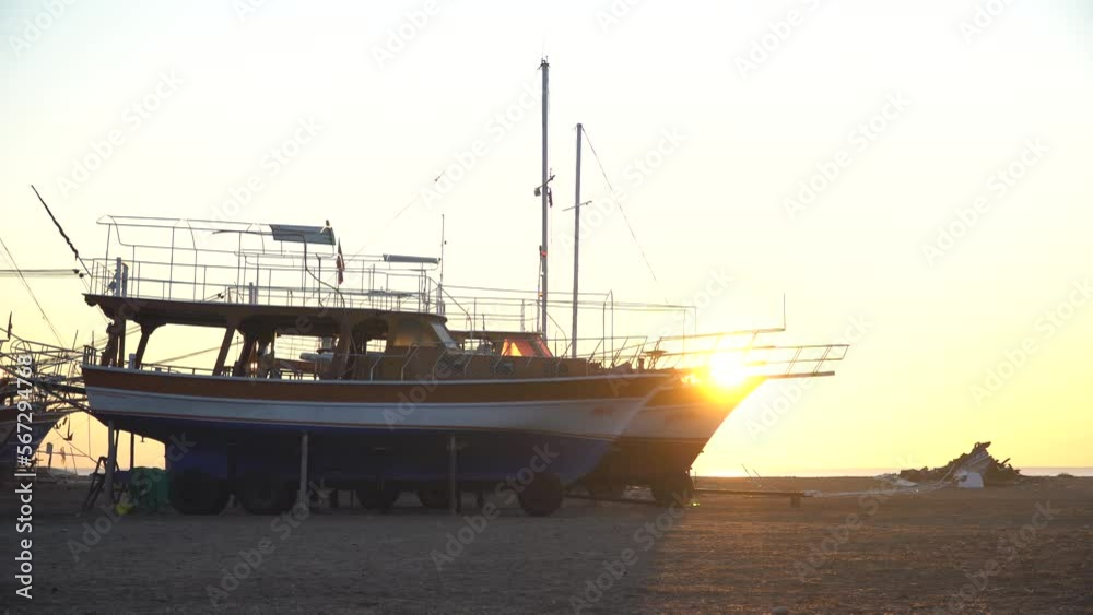 Ships on the shore against the backdrop of sunrise Ships on the shore against the backdrop of sunrise
