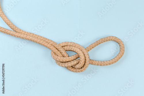 Rope knot Overhand loop on blue background close-up