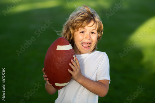 Sport kid. Kid with american football, rugby ball. Cute portrait of a american football player.