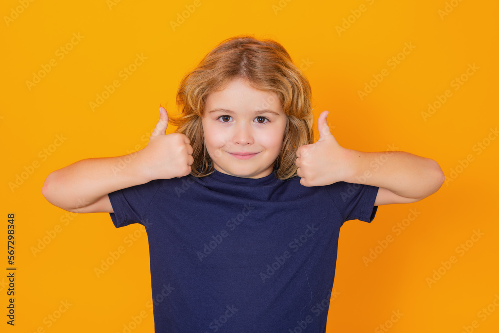 Child showing thumbs up on studio isolated background. Kid boy making thumbs up sign. Happy kid, happy and smiling emotions. Child showing thumbs up on studio isolated background. Kid boy making thumbs up sign. Happy kid, happy and smiling emotions.