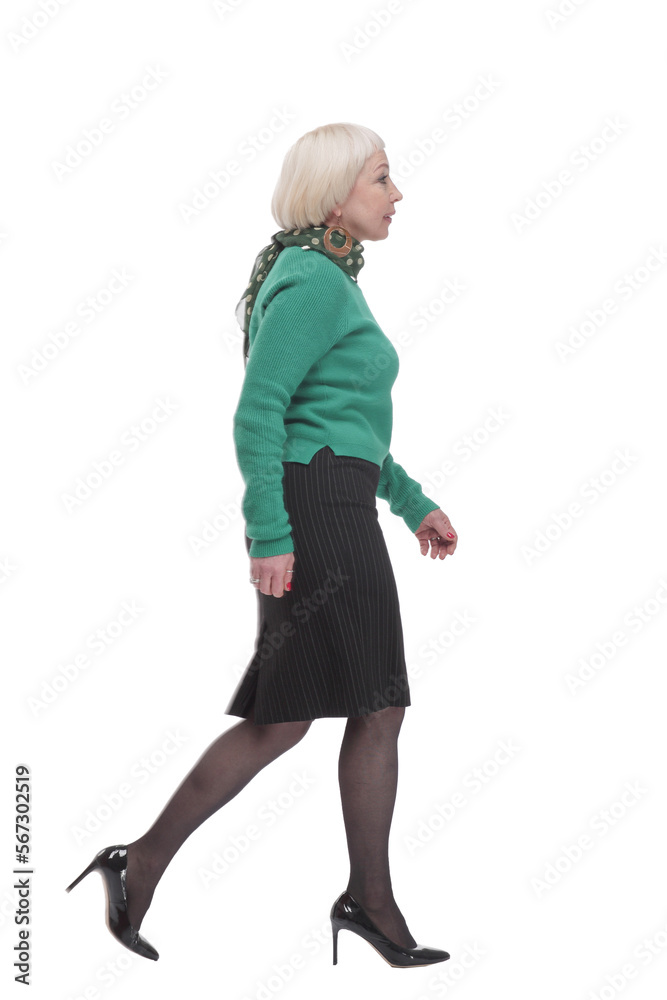 in full growth. woman in a green jumper striding forward. in full growth. woman in a green jumper striding forward.