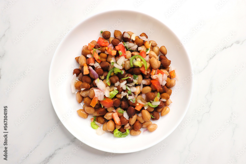 High in protine boiled black chana or chickpea salad. Chopped tomatoes, onion, chilies, and coriander mixed with boiled peanuts or bengal gram. Weight loss meal. Served with Lemon. Copy space. High in protine boiled black chana or chickpea salad. Chopped tomatoes, onion, chilies, and coriander mixed with boiled peanuts or bengal gram. Weight loss meal. Served with Lemon. Copy space.