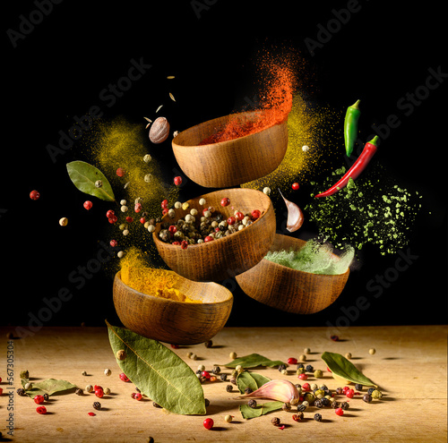 Fototapeta Naklejka Na Ścianę i Meble -  Spices and seasonings powder splash, explosion on black