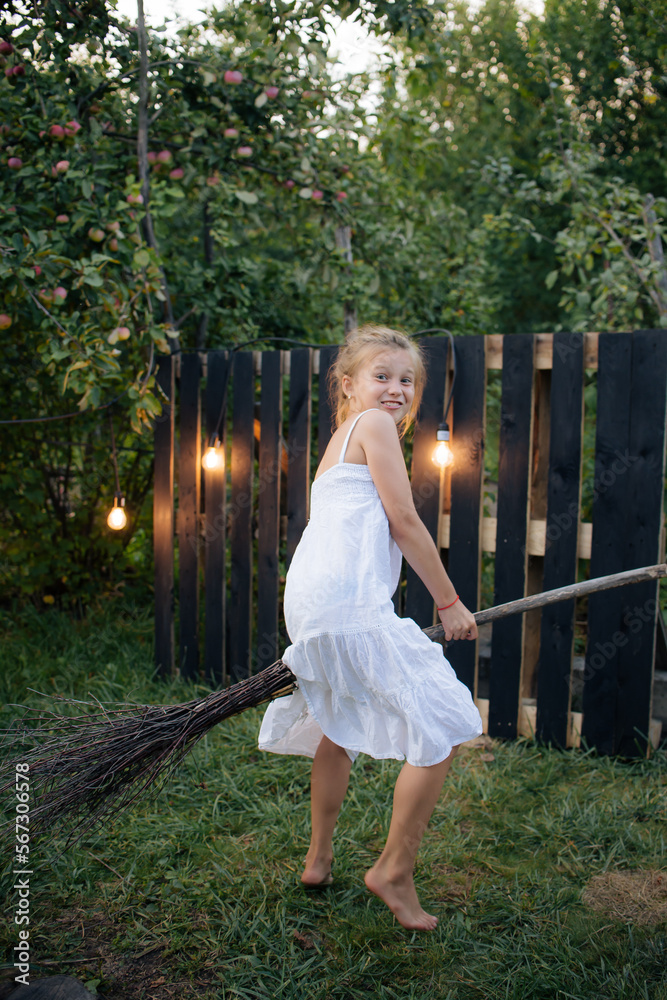 little child playing in the park, girl with a broom little child playing in the park, girl with a broom