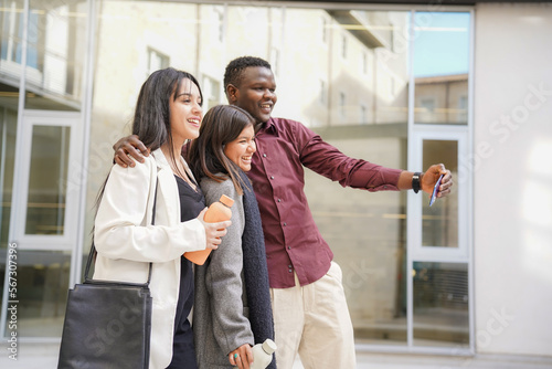 multiethnic group of businesspeople take a selfie with the mobile phone outside the office