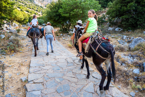 Girl riding a donkey to visit Cave of Diktaion Andron. © _jure