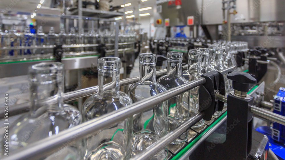 Closeup view of modern vodka bottling line.