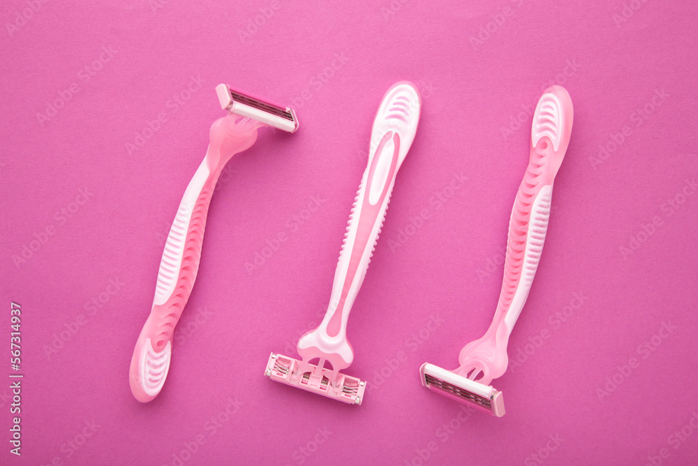 Pink razors for hair removal on pink background