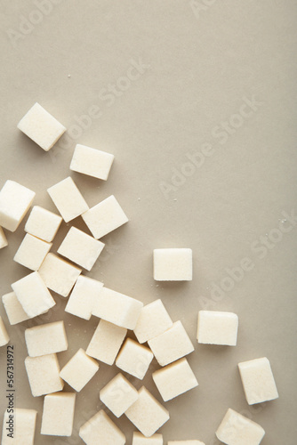 Sugar cubes on grey background. Vertical photo.