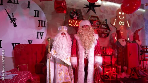 Santa Claus and Saint Nicholas on a festive background photo