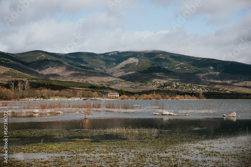 Fototapeta Naklejka Na Ścianę i Meble -  landscape of a swamp in the mountains of madrid with a mountain in the background and a sky full of clouds with the tonalities that looks like a painting