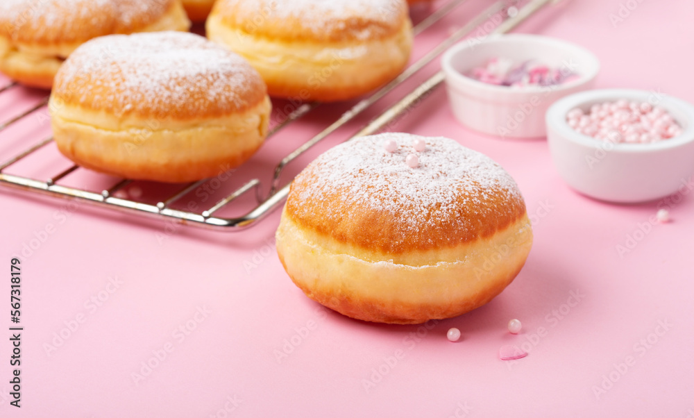 Donuts Doughnuts with Icing Sugar and Sprinkles on Pink Background