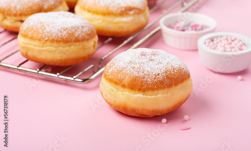 Donuts Doughnuts with Icing Sugar and Sprinkles on Pink Background