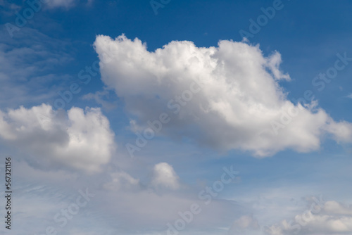 White cumulus clouds on a clear blue sky.
