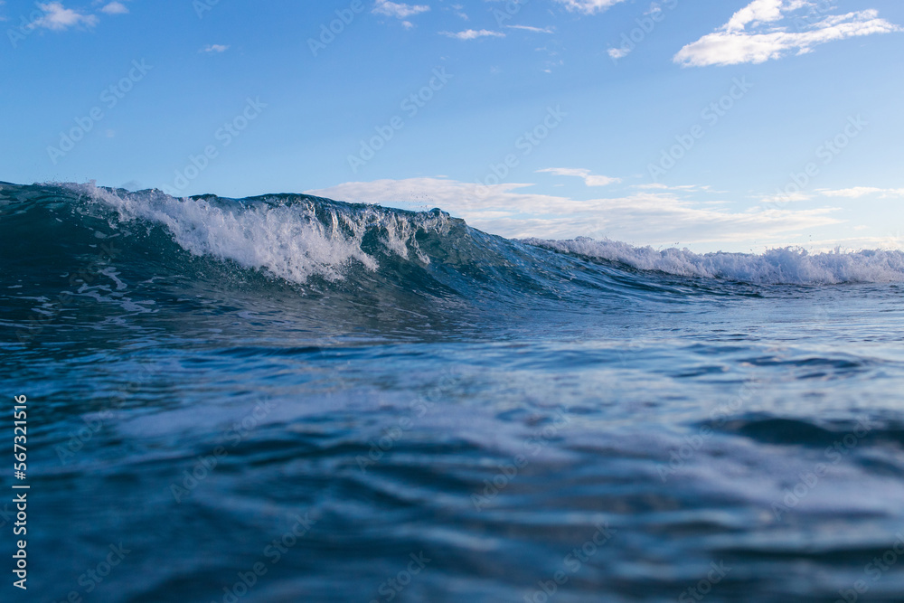 Beautiful blue wave breaking in the ocean.