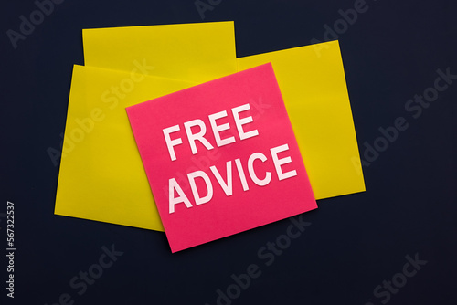 Free Advice - inscription of a pink square sticky note paper on dark background. Top view. Business, goal and target plan concept
