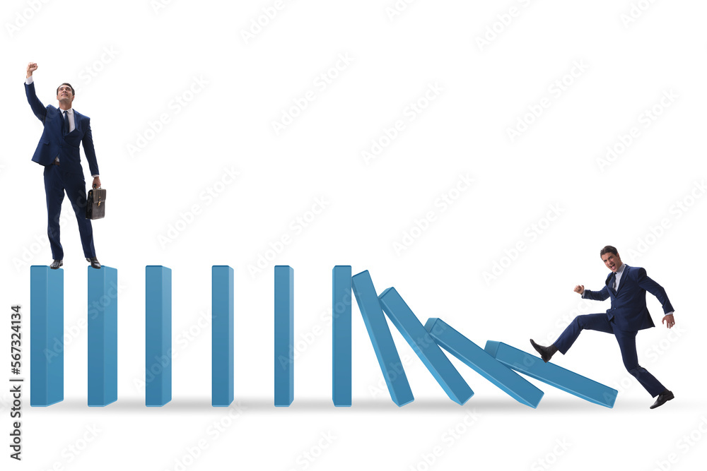 Businessman in domino effect concept Businessman in domino effect concept