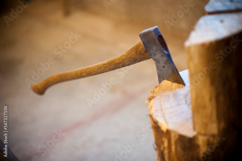 An ax sits in a stump of wood in a timber framers shop in Deforest, WI.