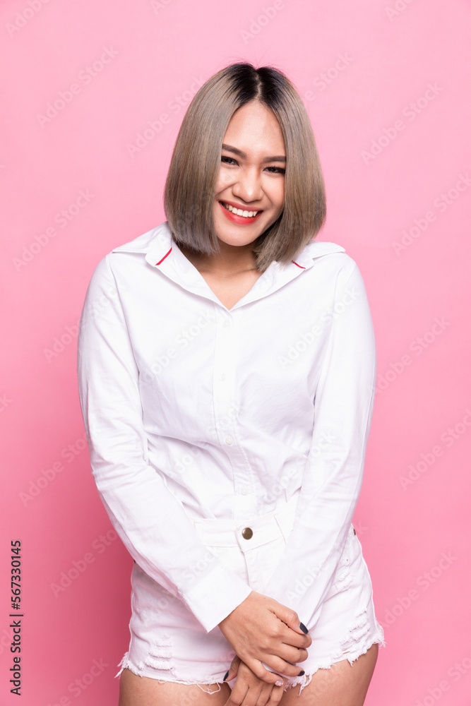Portrait attractive asian woman feeling happy in front of a bright pink background. Portrait attractive asian woman feeling happy in front of a bright pink background.