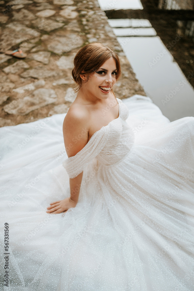 Dreamy portraits of beautiful bride on stone riverbank Dreamy portraits of beautiful bride on stone riverbank