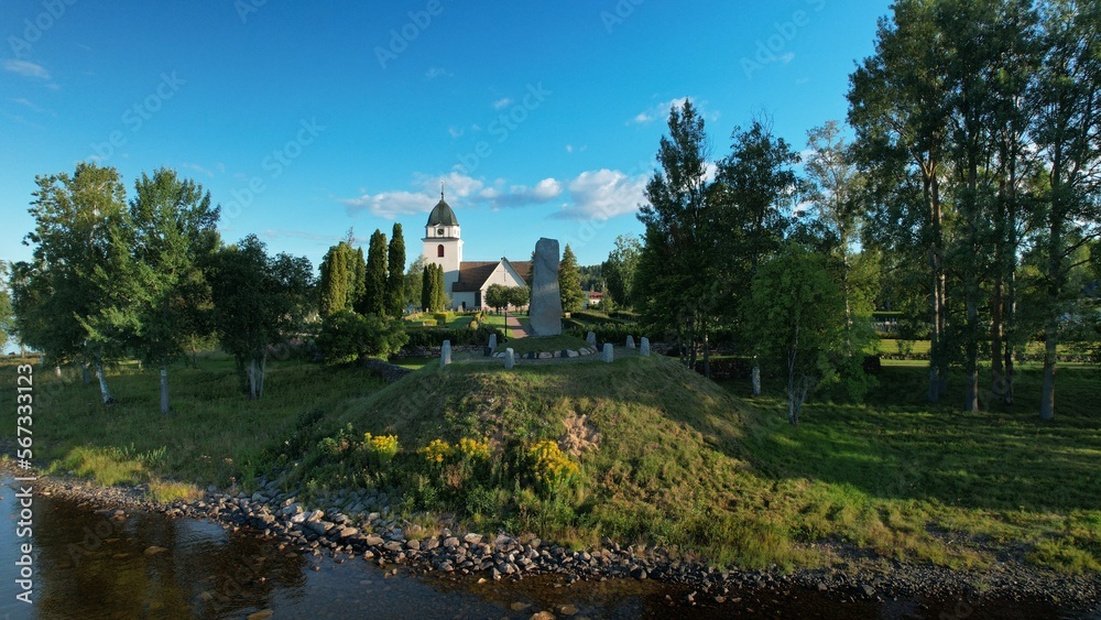A 15th century church of Sweden and the Vasa monument in Rättvik. Memorial stone of king Gustav Vasa by the lakeside of Siljan lake, Rättviks kyrka
