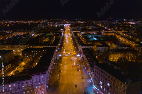 Top view of the night city in winter. Movement of cars on lighted streets and intersections