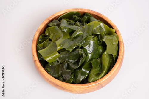 Seaweed wakame in wooden bowl isolated on gray background. japanese food