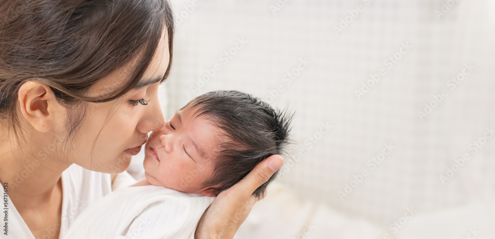 happy loving family. mother playing with her baby hugging in the bedroom , portrait of asian mother playing with newborn baby, health care family love together. asian girl lifestyle.. happy loving family. mother playing with her baby hugging in the bedroom , portrait of asian mother playing with newborn baby, health care family love together. asian girl lifestyle..