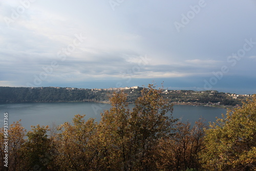  View of Albano lake near Castelgandolfo and the summer palace of the Pope, general view of Nemi lake and houses in Nemi town, fountain, sales counter of wild strawberries, Lazio Rome Italy © Dostbulut