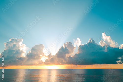 Sunset on sea background. Nature wallpaper with summer sea. Morning evening, sunshine. Water sea texture. Calm sunrise on tropical sea.