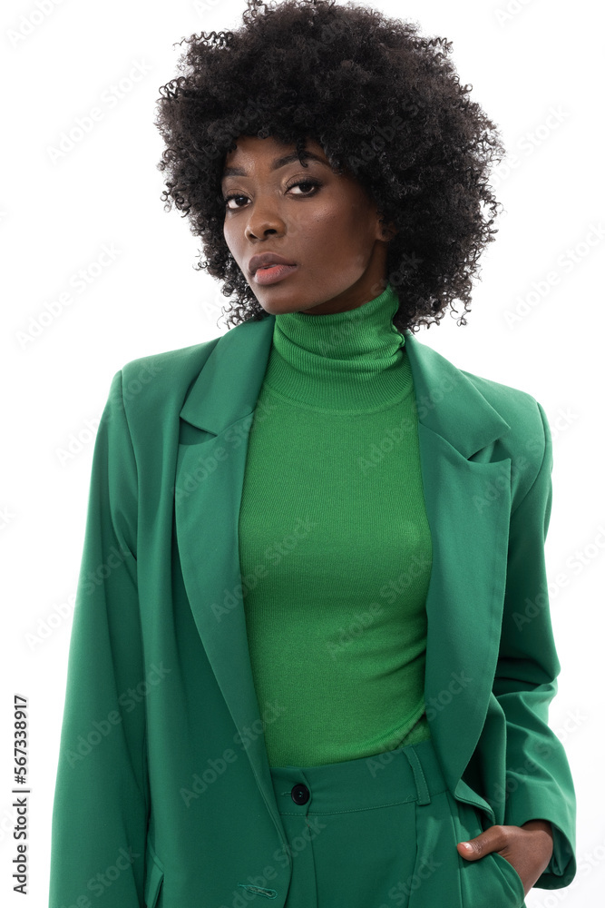 Fashionable brunette with green suit and handbag on isolated white background. Fashionable brunette with green suit and handbag on isolated white background.