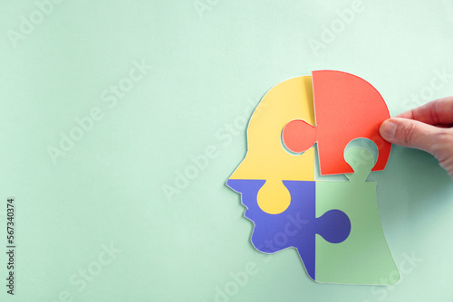 Hands holding jigsaw puzzle head shape, Autism awareness, Autism spectrum disorder (ASD), World Autism Awareness Day photo