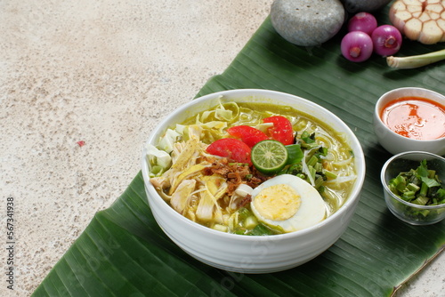 soto ayam, chicken soup with a yellow sauce photo