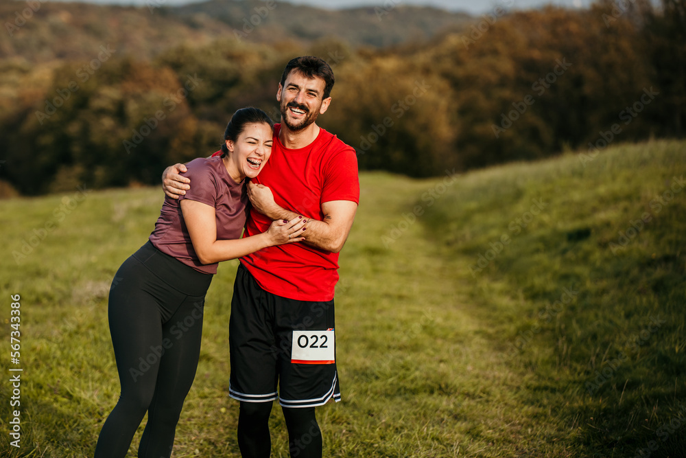 Loving embraced fit diverse couple exercise outdoors. They are wearing sports clothing, smiling, preparing, and supporting each other. Loving embraced fit diverse couple exercise outdoors. They are wearing sports clothing, smiling, preparing, and supporting each other.