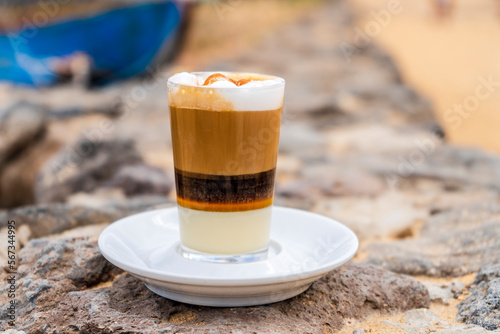 Delicious barraquito coffee with liquor and condensed milk, typical for Canary Island,  Spain photo