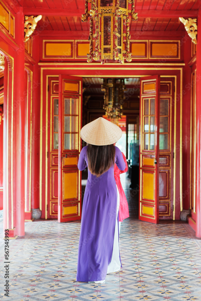 Woman in Ao Dai inside of Imperial Royal Palace of Nguyen dynasty in Hue, Vietnam
