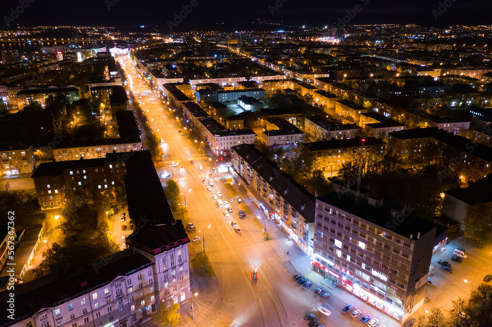 Top view of the night city in winter. Movement of cars on lighted streets and intersections