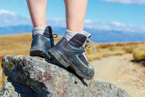 Hiking boot closeup on mountain rocks