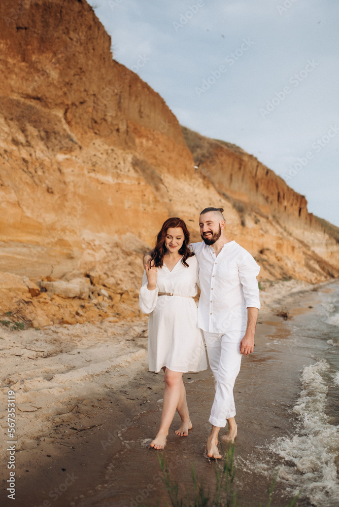 a guy with a girl in white clothes on the seashore a guy with a girl in white clothes on the seashore