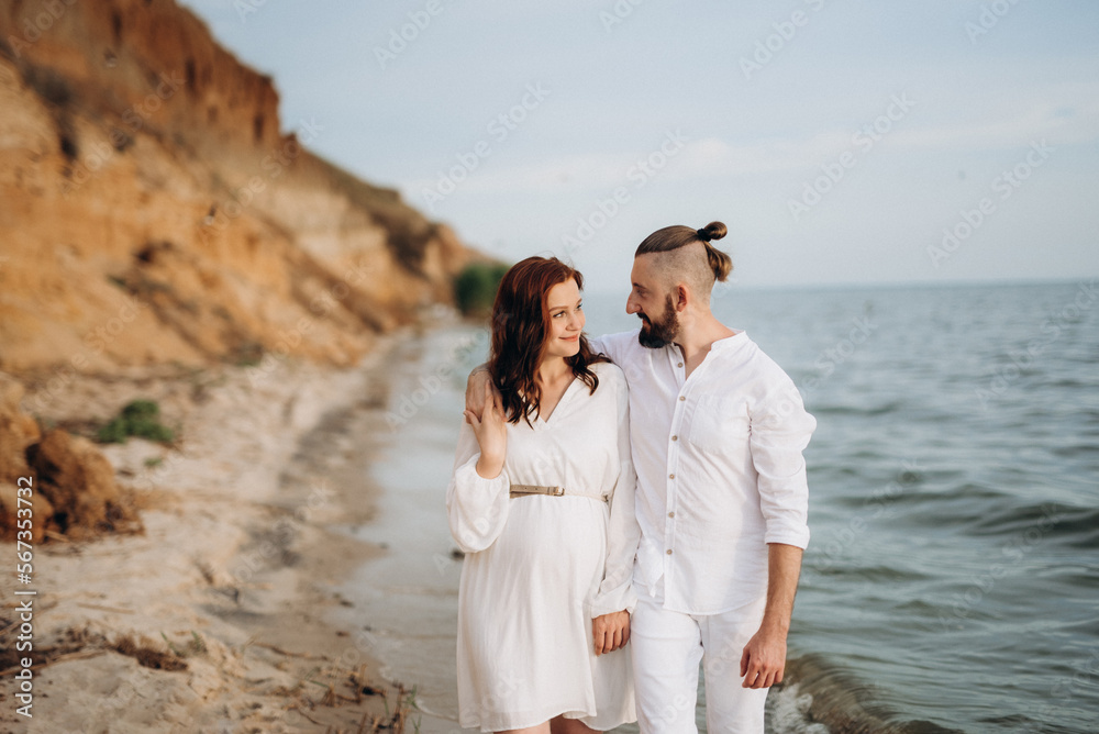 a guy with a girl in white clothes on the seashore a guy with a girl in white clothes on the seashore