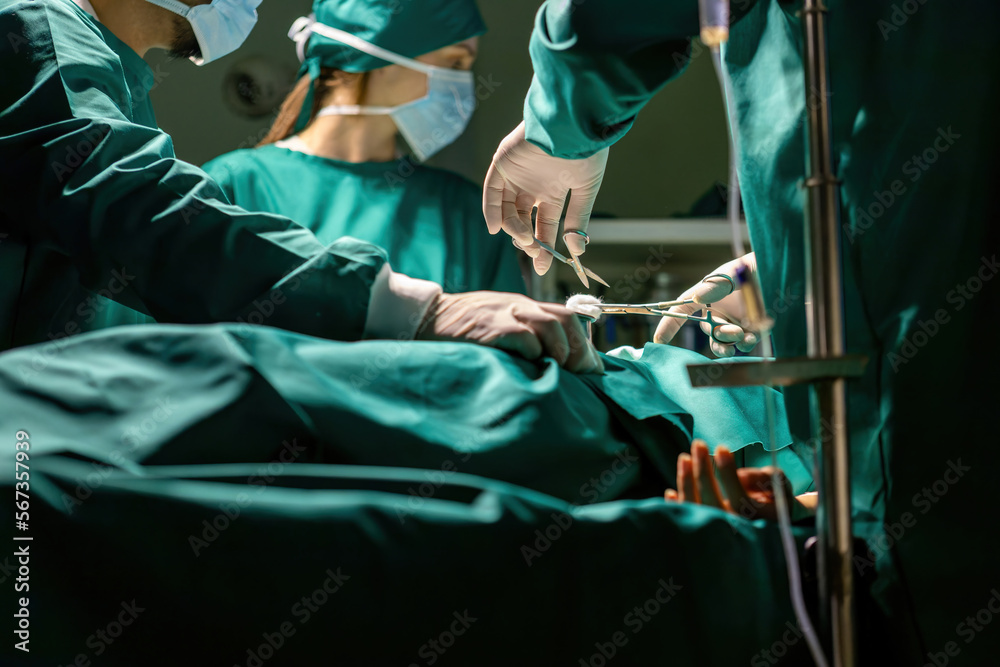 emergency doctor team working using tools to save people. medical staff team wearing uniform helping patient in surgery with equipment. specialist surgical group performing medical tools procedure