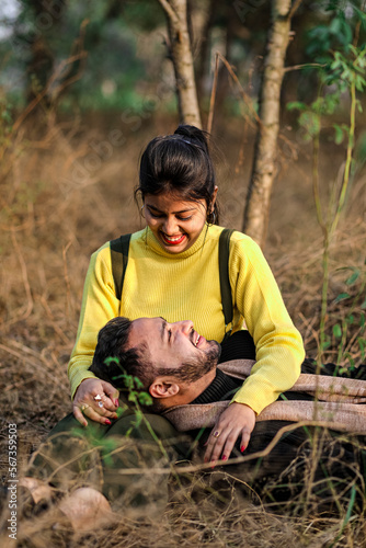 Pre wedding shot of an Indian couple in Nature's trail in Delhi, India. Romantic couple Shoot. Bride and groom in the natural forest of with trees. Mountain wedding Forest wedding Wedding photo shoot.